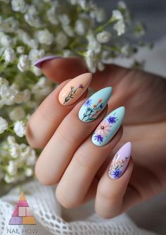 Nature's Whimsy: Adorn your fingertips with the delicate touch of spring! These almond-shaped nails feature a hand-painted floral design on a pastel canvas, perfect for embracing the season. Let nature's beauty blossom on your nails and find your spring inspiration at nailhow.com. Almond Blossom Nails, Bluebell Nail Art, Nail Art For Spring 2024, Spring Nails 2024 Flowers, Spring Floral Nails 2024, Mermaid Nail Art, Blue Glitter Nails, Geometric Nail Art, May Nails