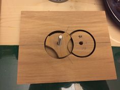 a wooden clock sitting on top of a table