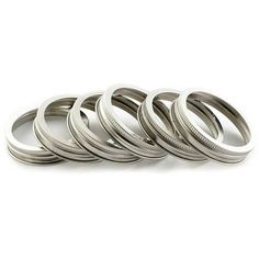 six silver wedding rings on a white background