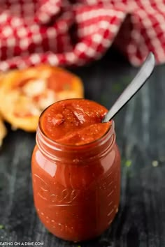 a jar filled with sauce sitting on top of a table