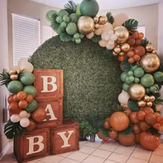 a baby shower is decorated with balloons and greenery