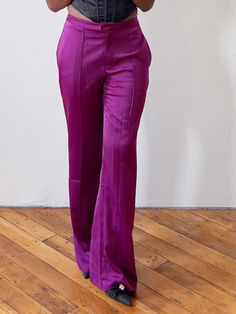 Designed with absolute luxury in mind, these Satin Boysenberry Trousers boast an exquisite sheen of premium satin in a deep rich Boysenberry color. Relaxed fit with a wide-leg silhouette, these trousers exude sophistication, femininity, and effortless glamour. Lightweight, unlined, and feminine wide-leg trousers feature functional pockets, a belt loop, and a tapered finish Fit: Tapered. There is no stretch, so order your appropriate pants size/jean size when it comes to these pants. Fabric: 95% Boysenberry Color, Purple Trousers, Women Trousers Design, Classy Fall Outfits, Satin Trousers, Pants Fabric, Feminine Women, Autumn Cozy, Wide Leg Trousers