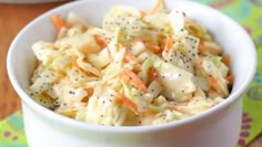 a white bowl filled with coleslaw and carrots