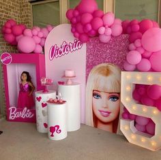 there is a barbie birthday party with balloons and decorations