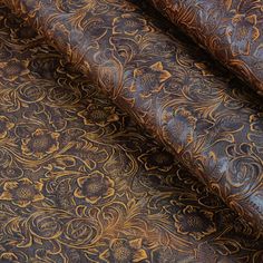 the fabric is brown and has gold designs on it, as well as an intricate pattern