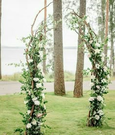 an outdoor ceremony setup with greenery and flowers