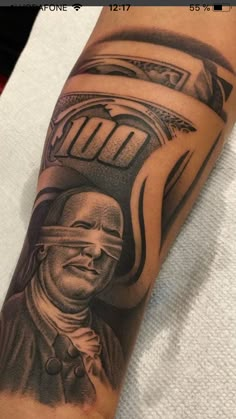 a man's arm with a portrait of a train conductor on it