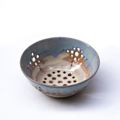 a blue and white bowl with holes in it