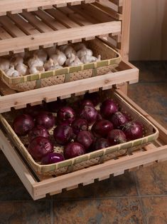 an open wooden box filled with red onions