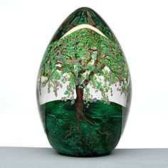 a glass vase with a tree painted on it