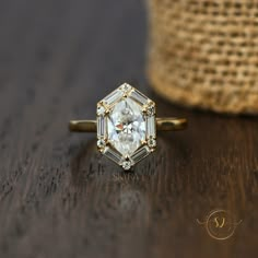 a diamond ring sitting on top of a wooden table