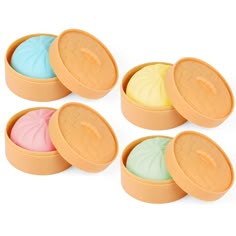 four round containers filled with different colored soaps