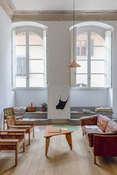 a living room filled with furniture and windows