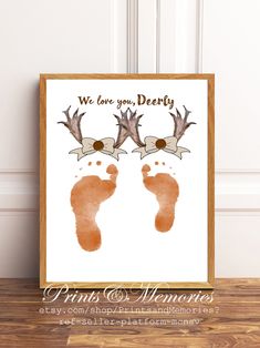 a poster with two baby footprints and the words, we love you dearly printed on it