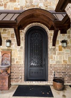 a black front door on a brick building