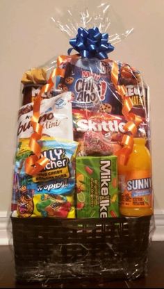 a basket filled with snacks and drinks on top of a table