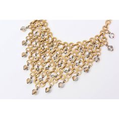 This is part of Chairish’s Costume Jewelry assortment.  This wonderful french bib geometric necklace has been attributed to Paco Rabanne, but is not signed. The inter-connecting, geometric brass links are with with fine precision and the faceted crystals are Swarovski in gray to radiant clear glass. There are 16 large crystals hanging and many smaller ones interspersed on the bib part. Even the clasp is a crystal. This necklace is adjustable as to how high or low you want to wear this around the Bronze Metal Jewelry For Evening, Metal Chain Link Evening Jewelry, Metal Chain Link Jewelry For Evening, Evening Metal Chain Link Jewelry, Elegant Gold Bib Necklace With Adjustable Chain, Elegant Gold Bib Necklace For Evening, Elegant Chainmail Chain Link Jewelry, Gold Art Deco Necklaces For Party, Elegant Bronze Metal Chain Necklace