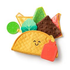 a taco and some other food items on a white surface with a smiling face