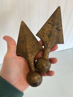 a person holding two metal objects in their hand