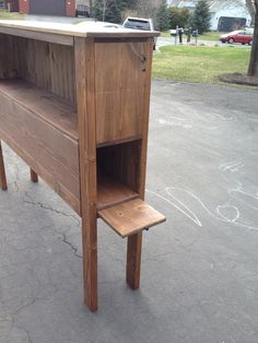 a wooden bench sitting in the middle of a parking lot