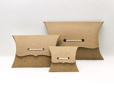 three brown paper bags with metal handles