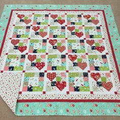 a quilted table runner with hearts on it