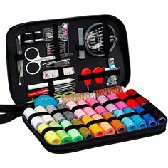 an open case filled with lots of crafting supplies including scissors, pins and thread