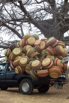 the truck is loaded with many hats on it's flatbed and ready to be picked up