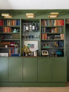 a green bookcase with many books on it