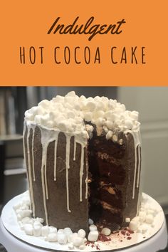 an indulgent hot cocoa cake with white chocolate icing and marshmallows