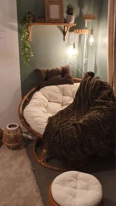 a living room filled with furniture next to a wall mounted shelf and potted plants