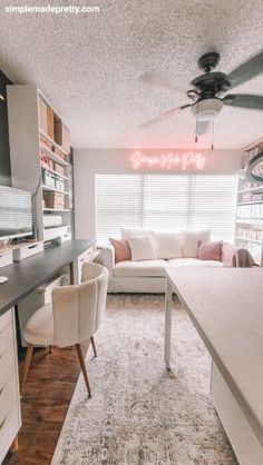 a living room filled with furniture and a ceiling fan