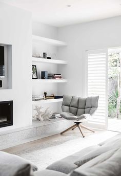 a living room with white walls and furniture