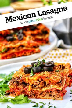 mexican lasagna with black olives and cilantro on top, served on a white plate