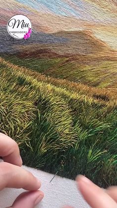 someone is using their fingers to draw grass