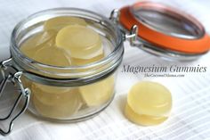 a glass jar filled with yellow gums next to a pair of scissors