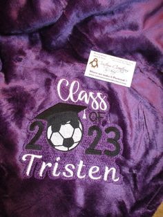 a purple jacket with a soccer ball on it and the words class of 2013 written in white