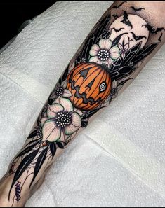 an orange and black butterfly tattoo on the leg