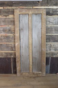 an old wooden door is in the middle of a room with wood planks on the walls