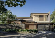 a modern house is shown in the middle of trees and bushes, with a car parked on the driveway