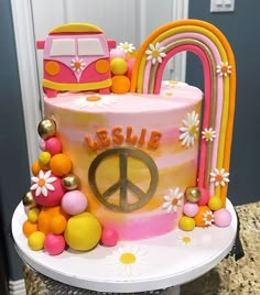 a peace sign cake is decorated with flowers and beads