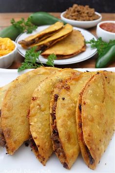 there are several different types of food on this plate and in the background is an assortment of other foods