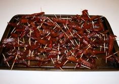 there are skewered meats and toothpicks on the tray ready to be eaten