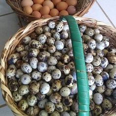 two baskets filled with eggs sitting on top of a tiled floor next to each other