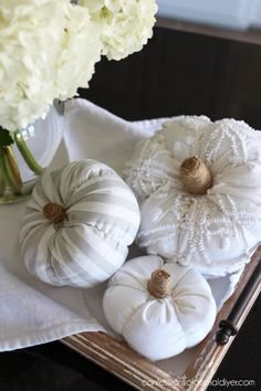 white pumpkins and hydrangeas on a tray