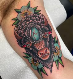 a bull with a clock on it's head is shown in this tattoo design