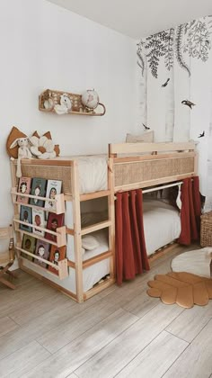 a child's bedroom with two bunk beds and toys on the floor in front of it