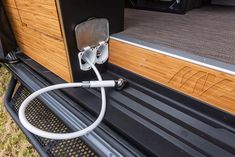 an electric charger plugged into the back of a truck