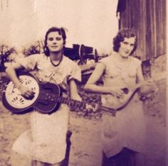 an old photo of two women holding guitars