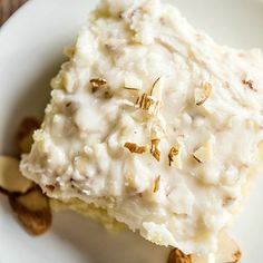 a close up of a plate of food with rice and nuts on the top,